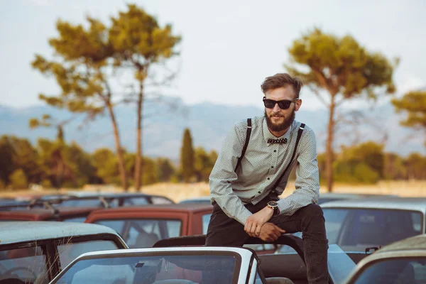 Young handsome stylish man, wearing shirt and bow-tie on the fie — Stock Photo, Image