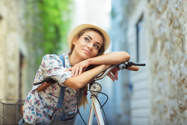 Glad kvinna med cykel på gatan i gamla stan — Stockfoto