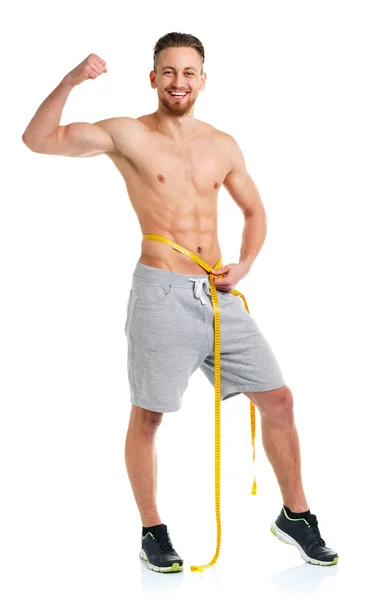 Hombre atlético con cinta métrica en el blanco — Foto de Stock