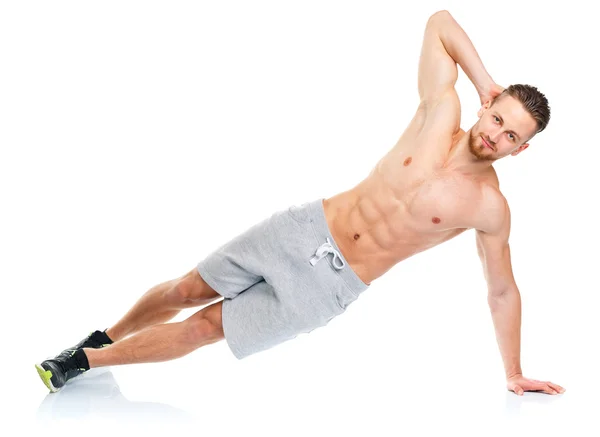Deporte atractivo hombre haciendo ejercicios de fitness en el blanco —  Fotos de Stock
