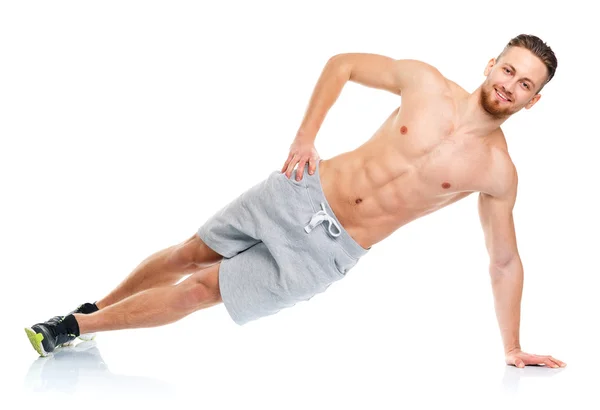 Sportovní atraktivní muž dělá fitness cvičení na bílé — Stock fotografie