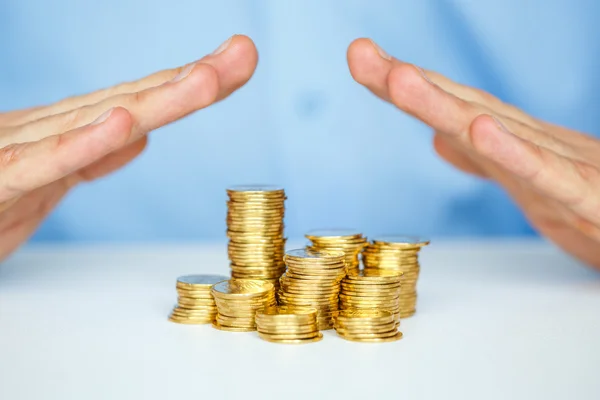 Skydda nya företagsstarten-med händerna och mynt — Stockfoto