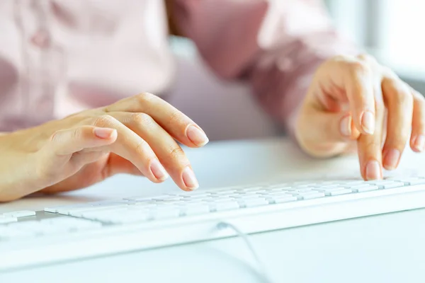 stock image Woman office worker typing on the keyboard