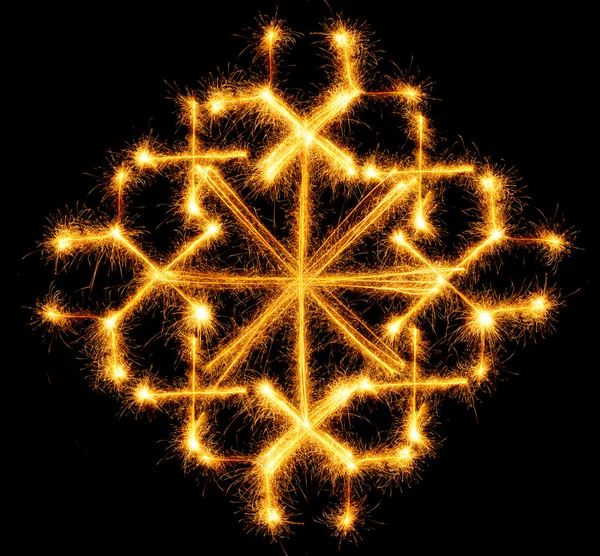 Snowflake made by sparkler on a black — Stock Photo, Image