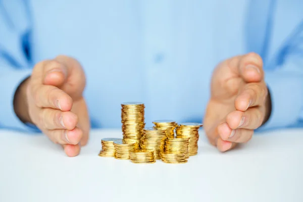 Skydda nya start-up affärsidé med händerna och mynt — Stockfoto