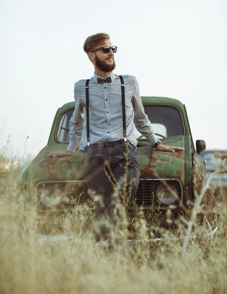 Young handsome stylish man, wearing shirt and bow-tie with old c — Stock Photo, Image