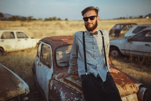 Young handsome stylish man, wearing shirt and bow-tie with old c — Stock Photo, Image