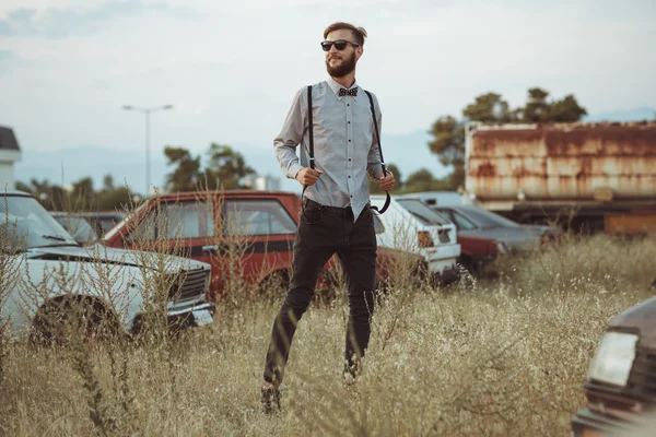 Young handsome stylish man, wearing shirt and bow-tie on the fie — Stock Photo, Image