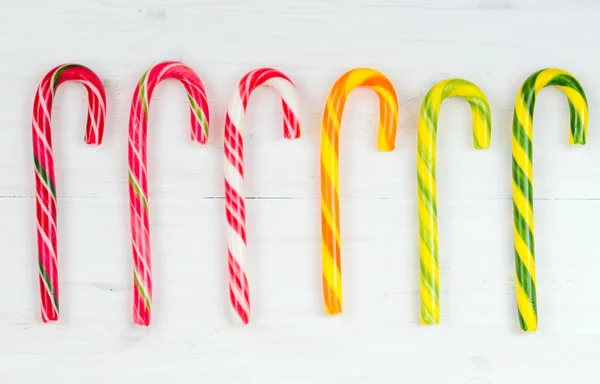 Christmas candy cane on a white wooden background — Stock Photo, Image