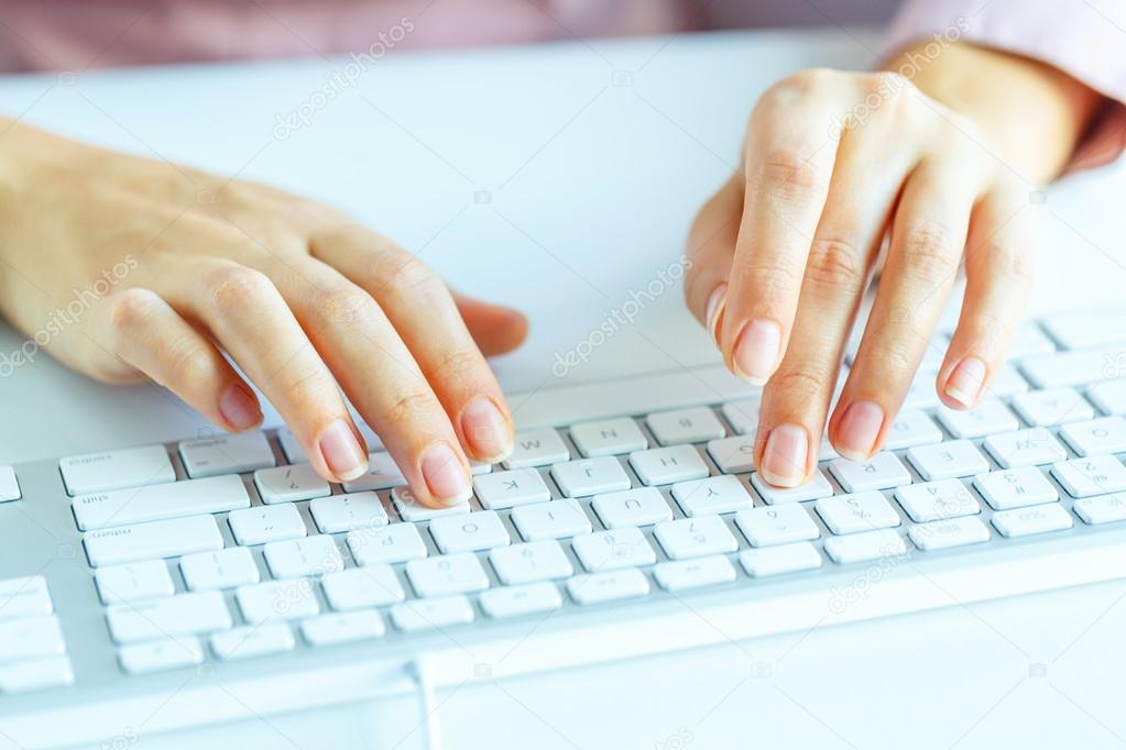 Woman office worker typing on the keyboard