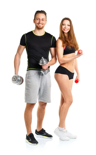 Athletic man and woman with dumbbells on the white — Stock Photo, Image