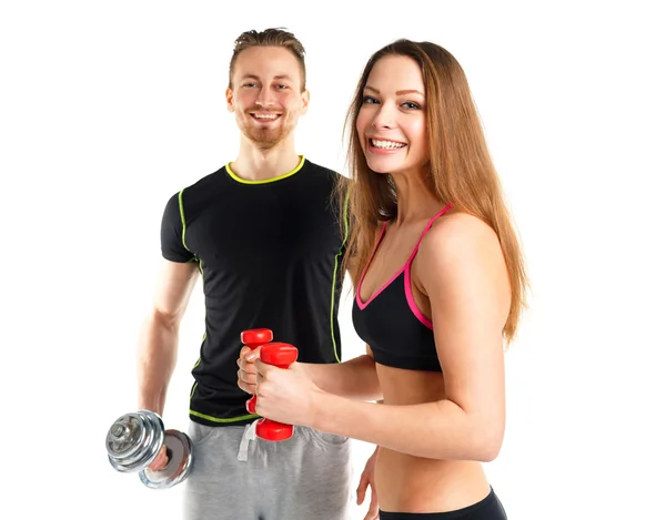 Athletischer Mann und Frau mit Hanteln auf dem weißen — Stockfoto