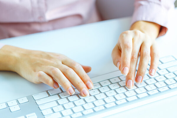 Женщина-офисный работник печатает на клавиатуре
