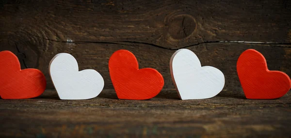 Red and white hearts on old wooden background — Stock Photo, Image