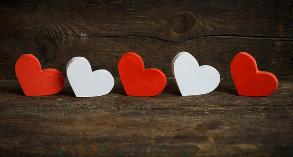 Red and white hearts on old wooden background — Stock Photo, Image