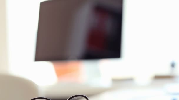 Work table with glasses and computers — Stock Video