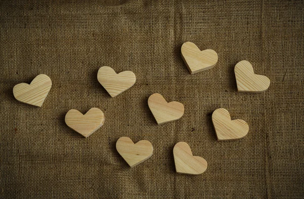 Wooden hearts on sackcloth background — Stock Photo, Image