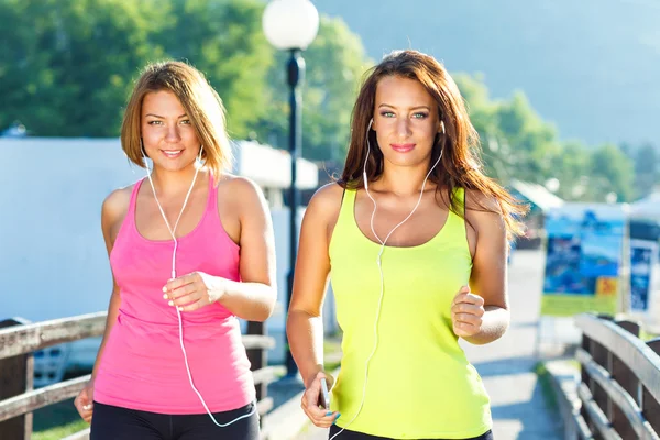 Two cute girls jogging outdoors — Stock Photo, Image