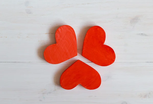 Red hearts on white wooden background — Stock Photo, Image