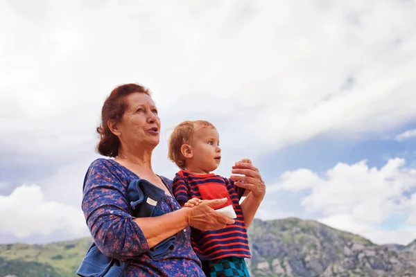 Grandmother holding her grandson in her arms — Stock Photo, Image