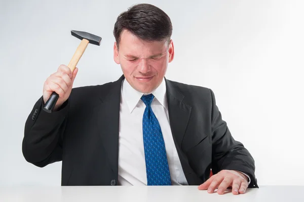 Businessman with hammer Stock Picture