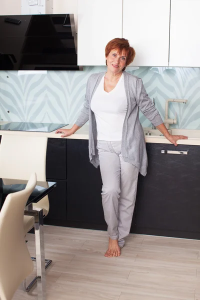 Happy adult woman on kitchen — Stock Photo, Image