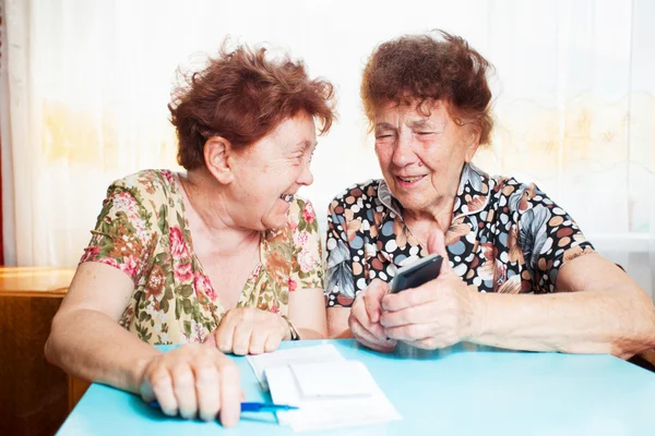 Two old women consider receipts