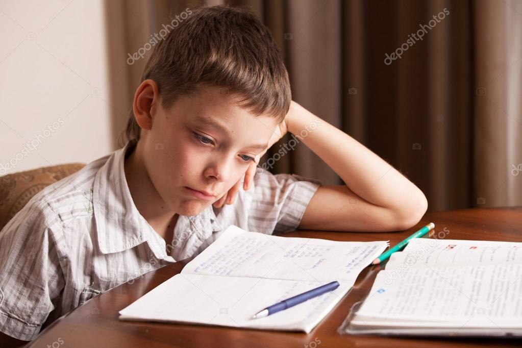 Sad boy doing homework