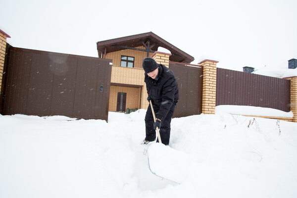 Man cleans snow shoveling 