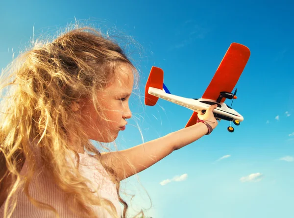 Girl playing with plane — Stock Photo, Image