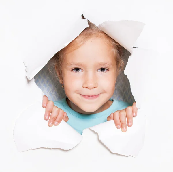 Child looking out of a hole in paper — Stock Photo, Image