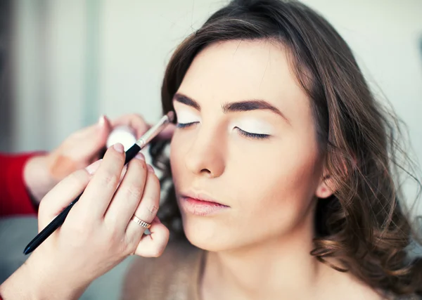 Woman applying makeup Stock Picture