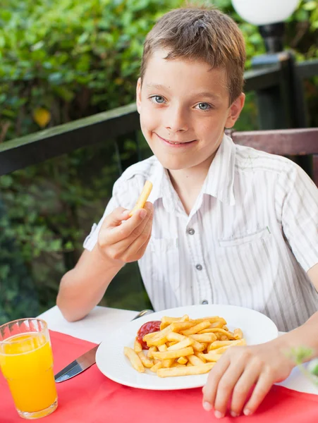 Niño comiendo patatas fritas —  Fotos de Stock