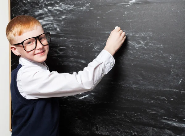 Boy near blackboard — Stock Photo, Image