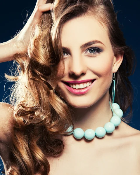 Beautiful woman with long curly brown hair — Stock Photo, Image