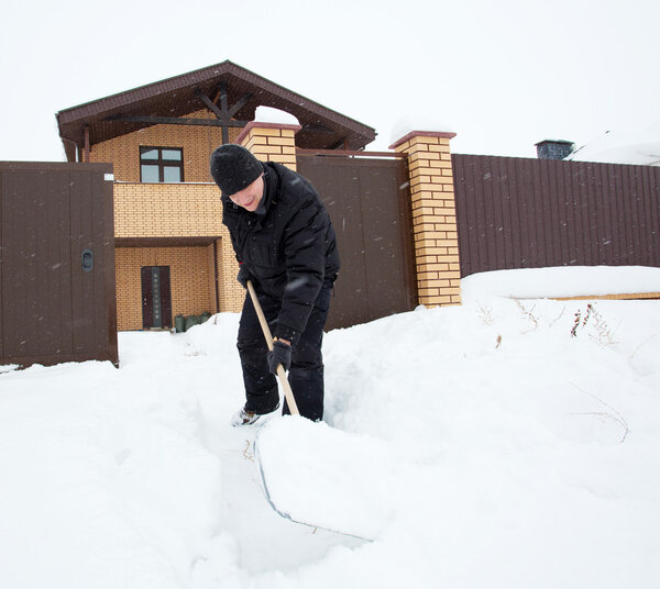 Man cleans snow shoveling