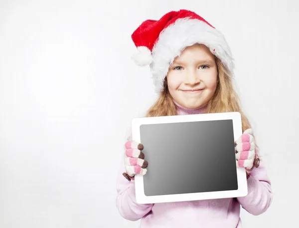 Niño en sombrero de Navidad con tableta — Foto de Stock