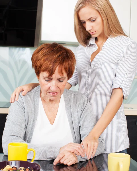 Daughter soothes sad mother — Stock Photo, Image