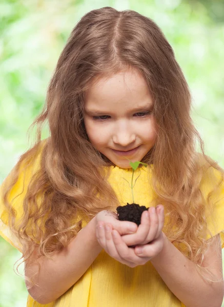 Child holding a sleedling — Stock Photo, Image