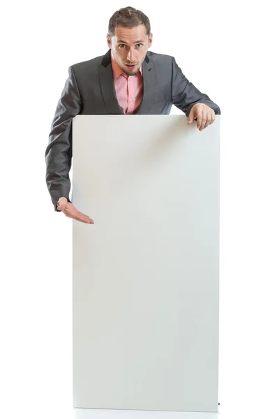 Engravatado homem de negócios exibindo cartaz — Fotografia de Stock
