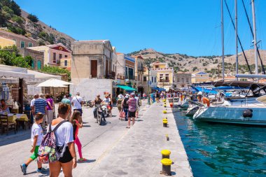 SYMI ISLAND, GREECE - JULY 5, 2015: Tourist on a promenade in the main town