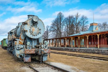 Retro steam locomotive train at old vintage railway station. Haapsalu, Estonia clipart