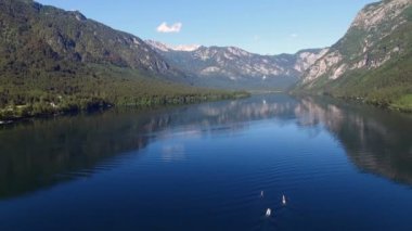 4 k. uçuş şaşırtıcı Bohinj Gölü sabah yukarıda. Kürek eğitim insanlar. Mavi derin su ve Julian Alps dağlar. Triglav Ulusal Parkı, Slovenya, Europe.