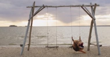 Dev Tyrranosaurus Rex şişme dinozor deniz sahilinde sallanıyor..