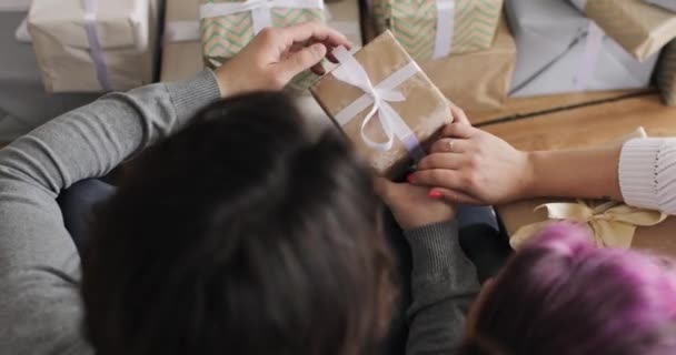 Familj man och kvinna packa upp presentförpackningar i juletid hemma, ovanifrån. — Stockvideo