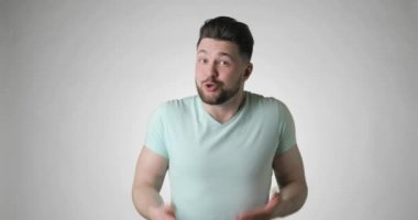 Kafası karışmış, sakallı, tişörtlü adam. Bilmiyorum, hiçbir fikrim yok..