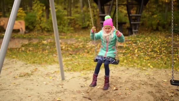 Beautiful little girl on swing — Stock Video