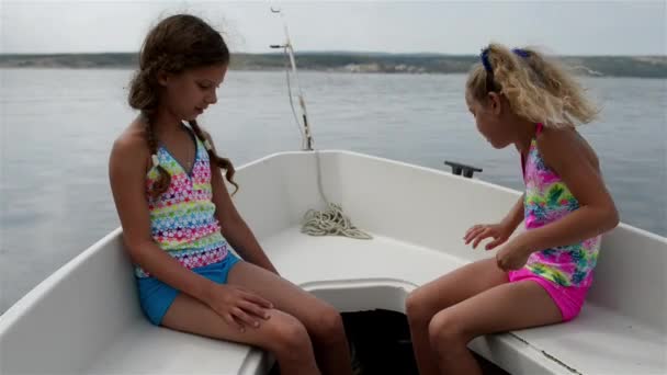 Две маленькие девочки плывут на лодке по Адриатическому морю — стоковое видео