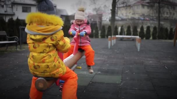 Two beautiful little girls on swing — Stock Video