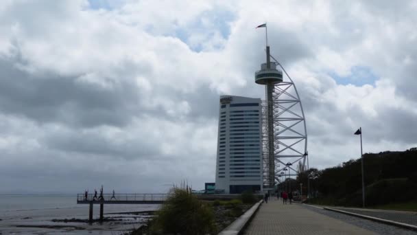 LISBON, PORTUGAL - MART 28 2016: Vasco da Gama Tower is 145 m lattice tower with skyscraper built over Tagus river, named after explorer, who was first European to arrive in India by sail, in 1498. — Stock Video